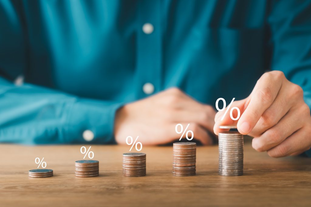 Professional stacking coins and percentage symbols to illustrate business value growth and financial metrics