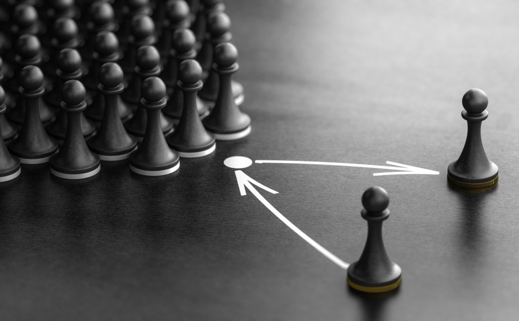 Servant leadership concept illustrated with chess pawns showing individual leadership paths diverging from the group