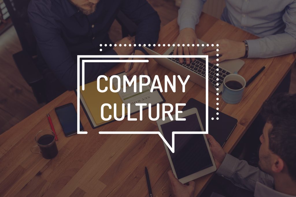 Team meeting overhead view with "Company Culture" text overlay