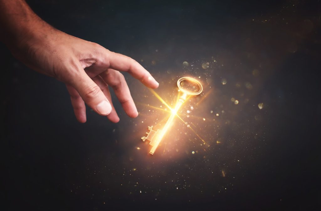 Hand reaching toward glowing light bulb symbolizing leadership inspiration and innovation