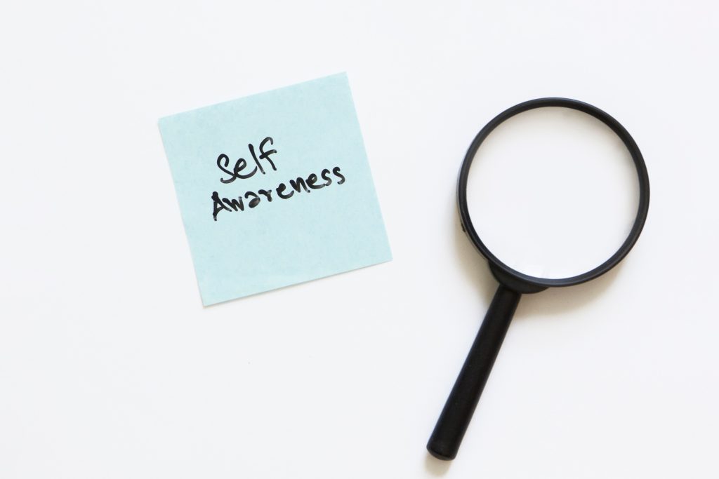Self-awareness concept with magnifying glass and sticky note