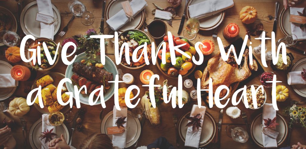 Give thanks with a grateful heart—overhead view of hands around a dining table