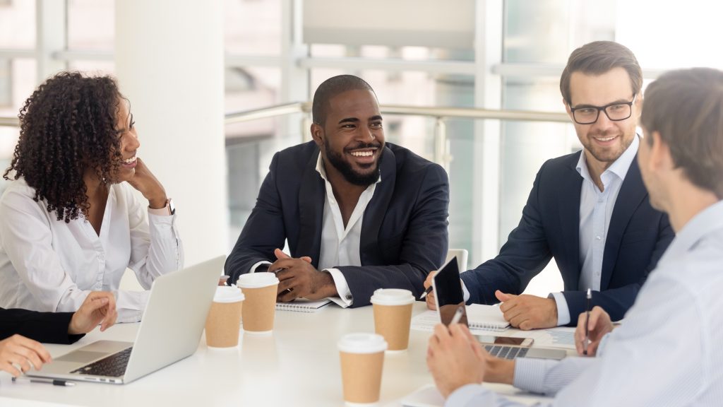 Diverse business team in collaborative meeting discussing customer experience strategy