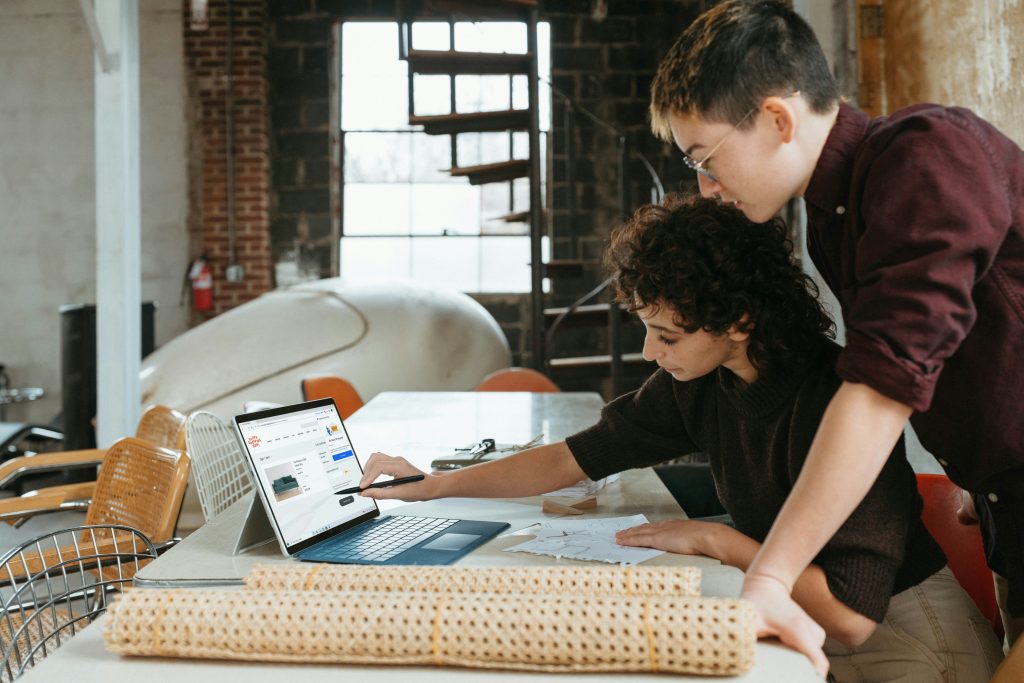 Two professionals collaborating on business strategy and design at a work table