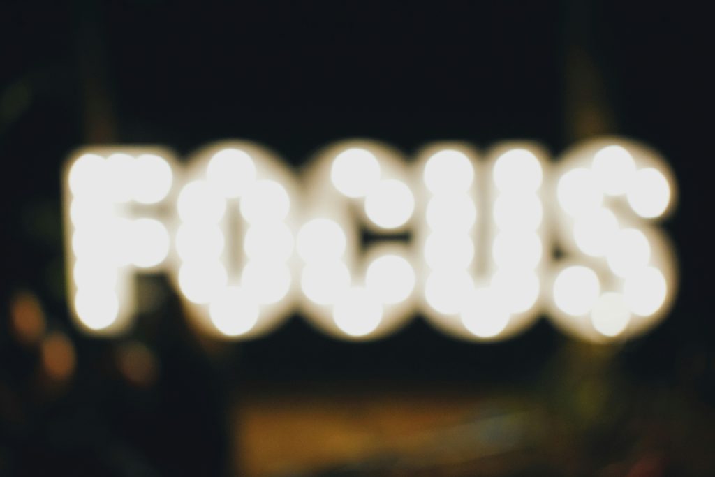 Illuminated neon "FOCUS" sign representing strategic business focus and priorities