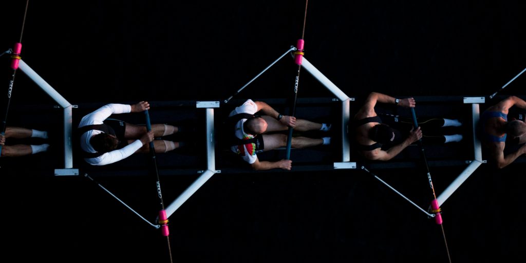 Sales and operations teams rowing in alignment toward shared growth goals