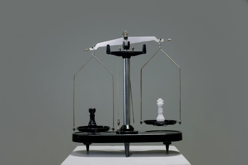 Balance scale with black platform and glass weighing chambers, representing competitive advantage through customer insights
