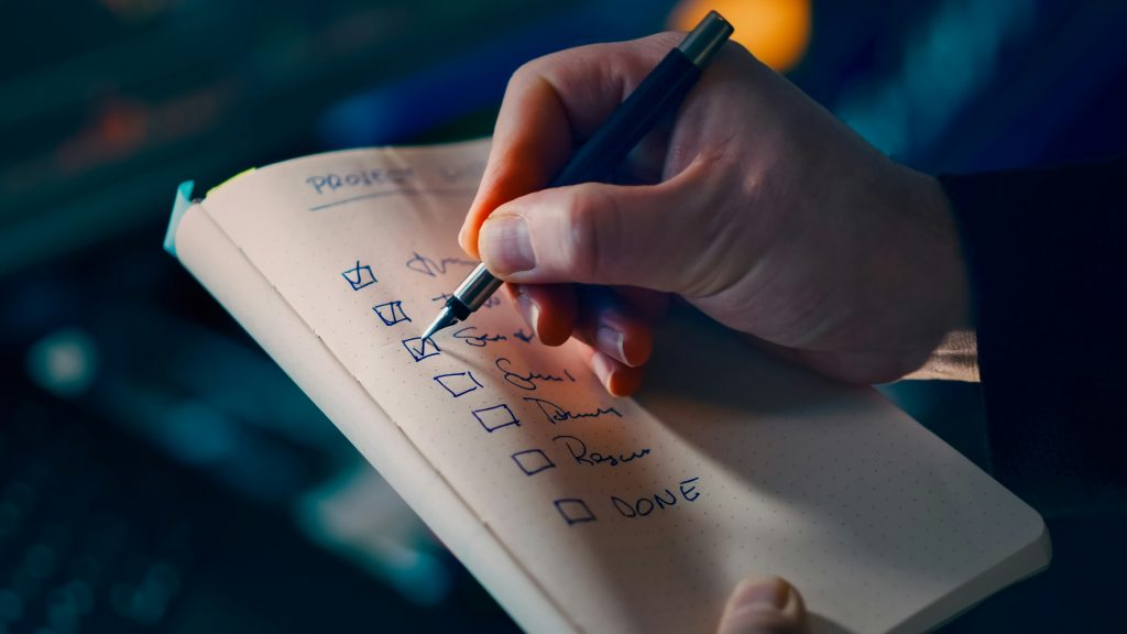 Person sketching a strategic plan or roadmap on paper, illustrating priority-setting and execution planning