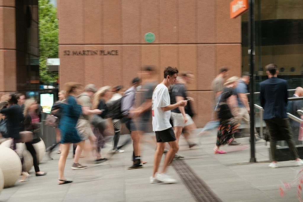 Busy urban pedestrians walking through downtown plaza, illustrating market segmentation and customer selection concepts