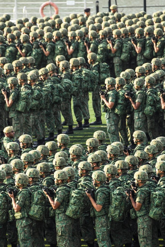 Large group of uniformed personnel standing in organized formation, representing operational alignment and coordinated