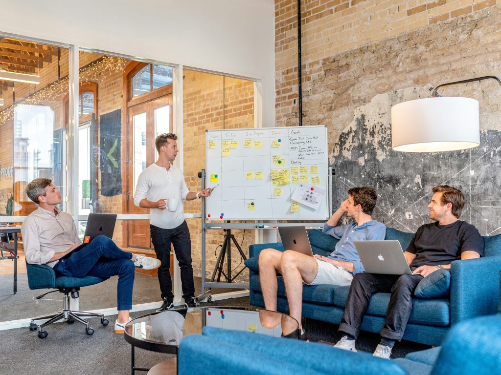 Startup team collaborating on business strategy and sales planning in modern office space