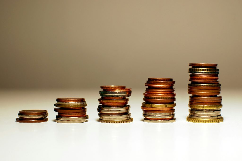 Stacked coins increasing in height representing revenue growth and business value progression