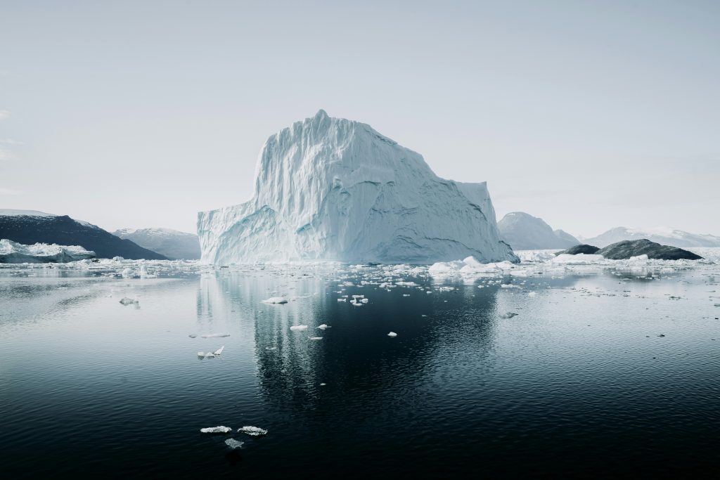 Iceberg partially submerged in arctic water, representing hidden performance drivers beneath visible business results